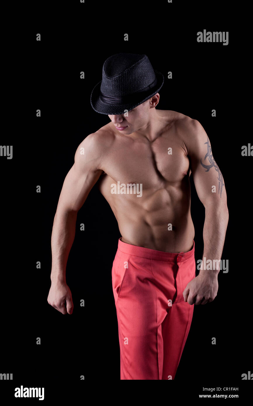 Sexy young man Stripper on black background Stock Photo - Alamy