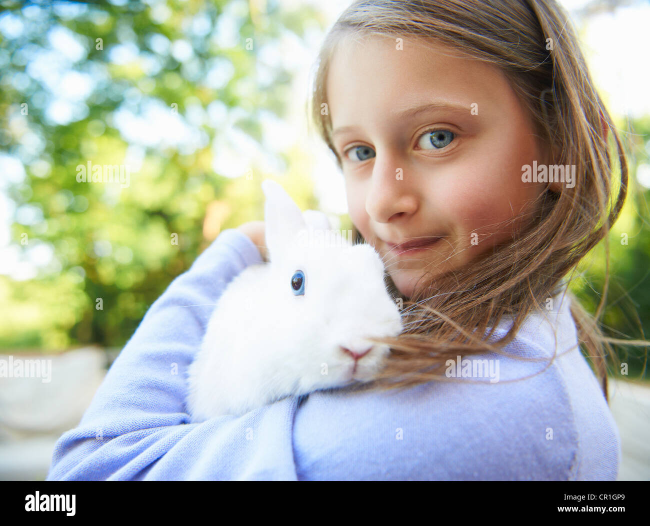 Close up of girl holding pet rabbit Stock Photo