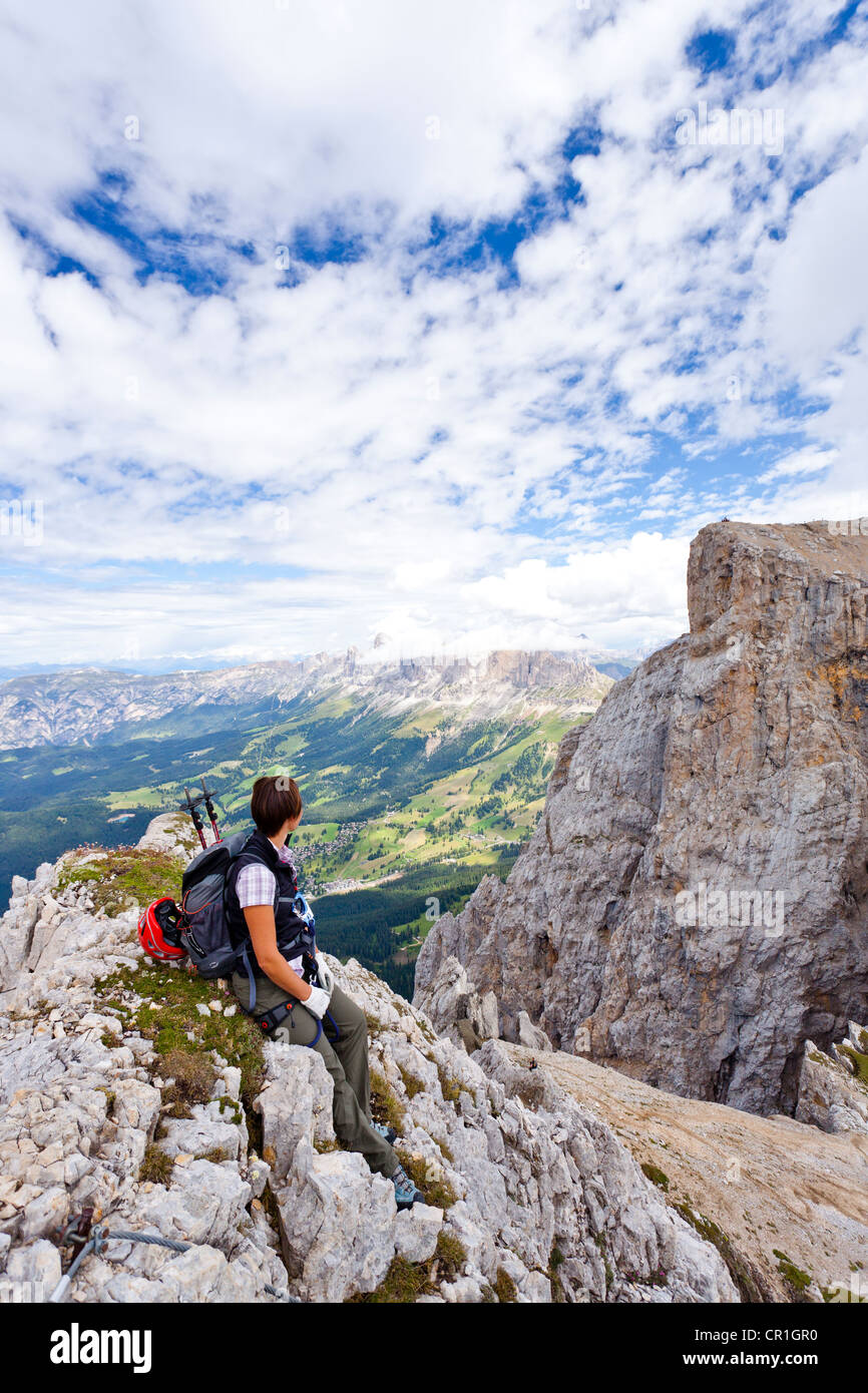 Climber on Mt. Latemar, roped climbing trail in the Dolomites, behind the Rosengarten group