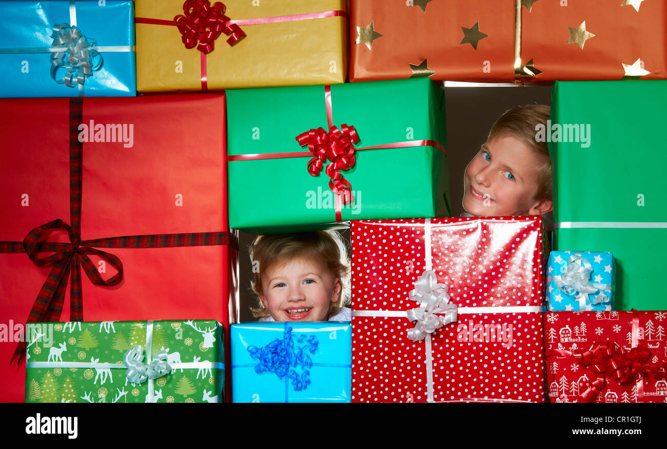 Children smiling in Christmas gift fort Stock Photo