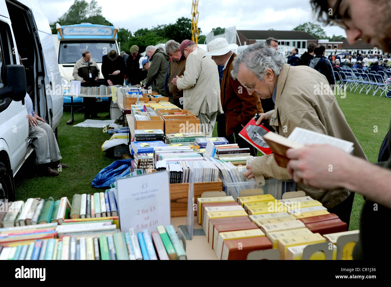 Browsing through second hand sports books on a stall at Horsham cricket