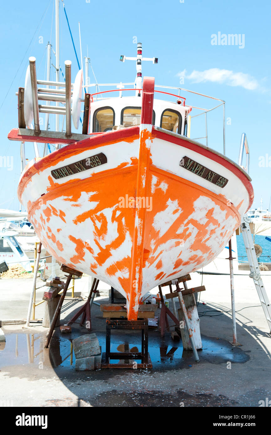 Old wooden fishing boat hull primed ready for topcoat Stock Photo