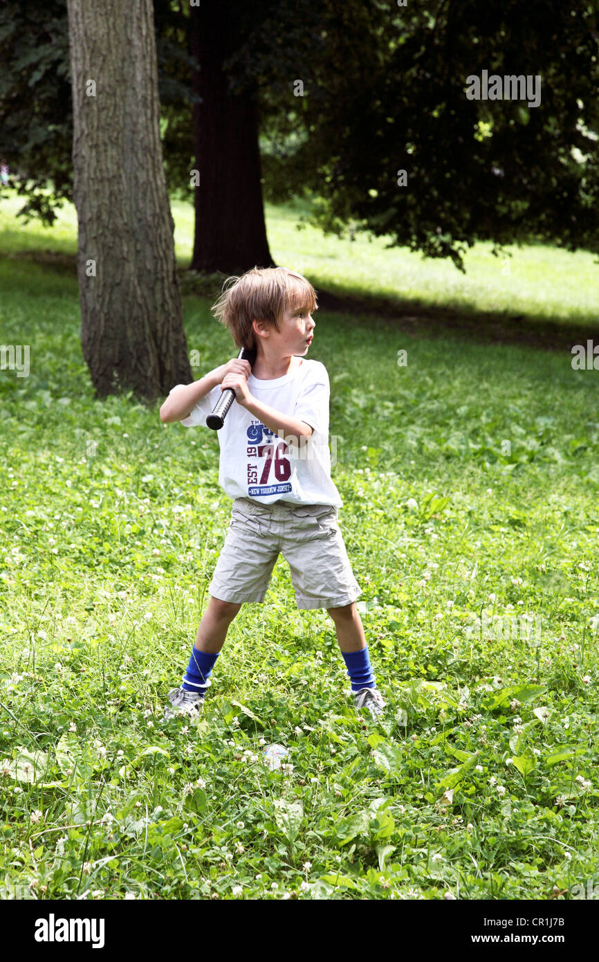 Small boy with large baseball bat fully prepared for the pitch from his