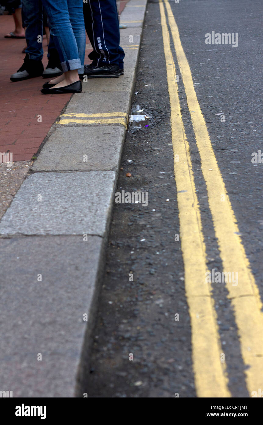 Shoppers stop on the pavement.  No parking. Stock Photo
