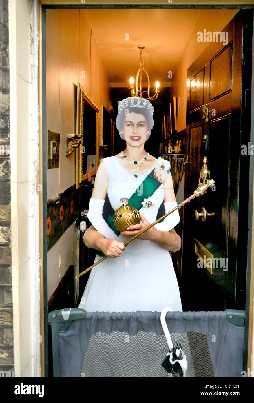 Eccentric British woman with a cardboard cutout of Queen Elizabeth the
