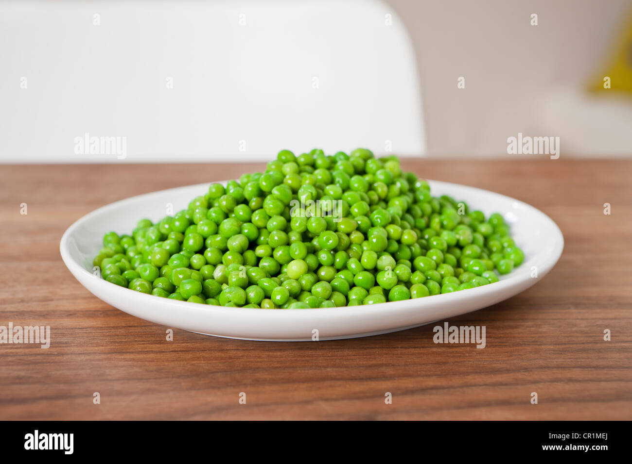 Close up of plate of peas on table Stock Photo