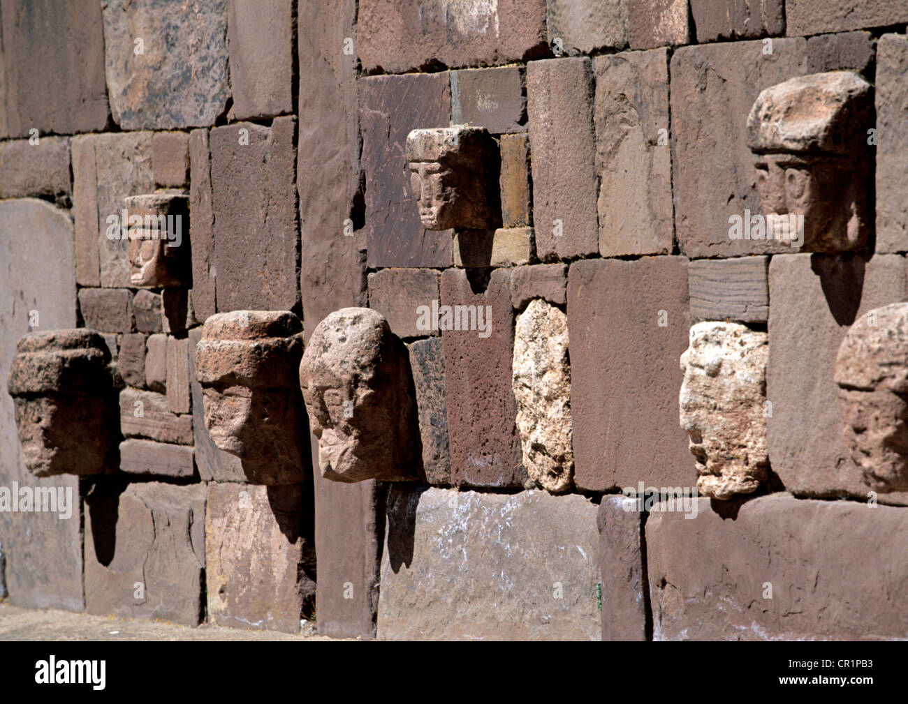 Bolivia, La Paz Department, Tiwanaku Pre-Inca archeological site, UNESCO World Heritage, carved stone head embedded in one of Stock Photo