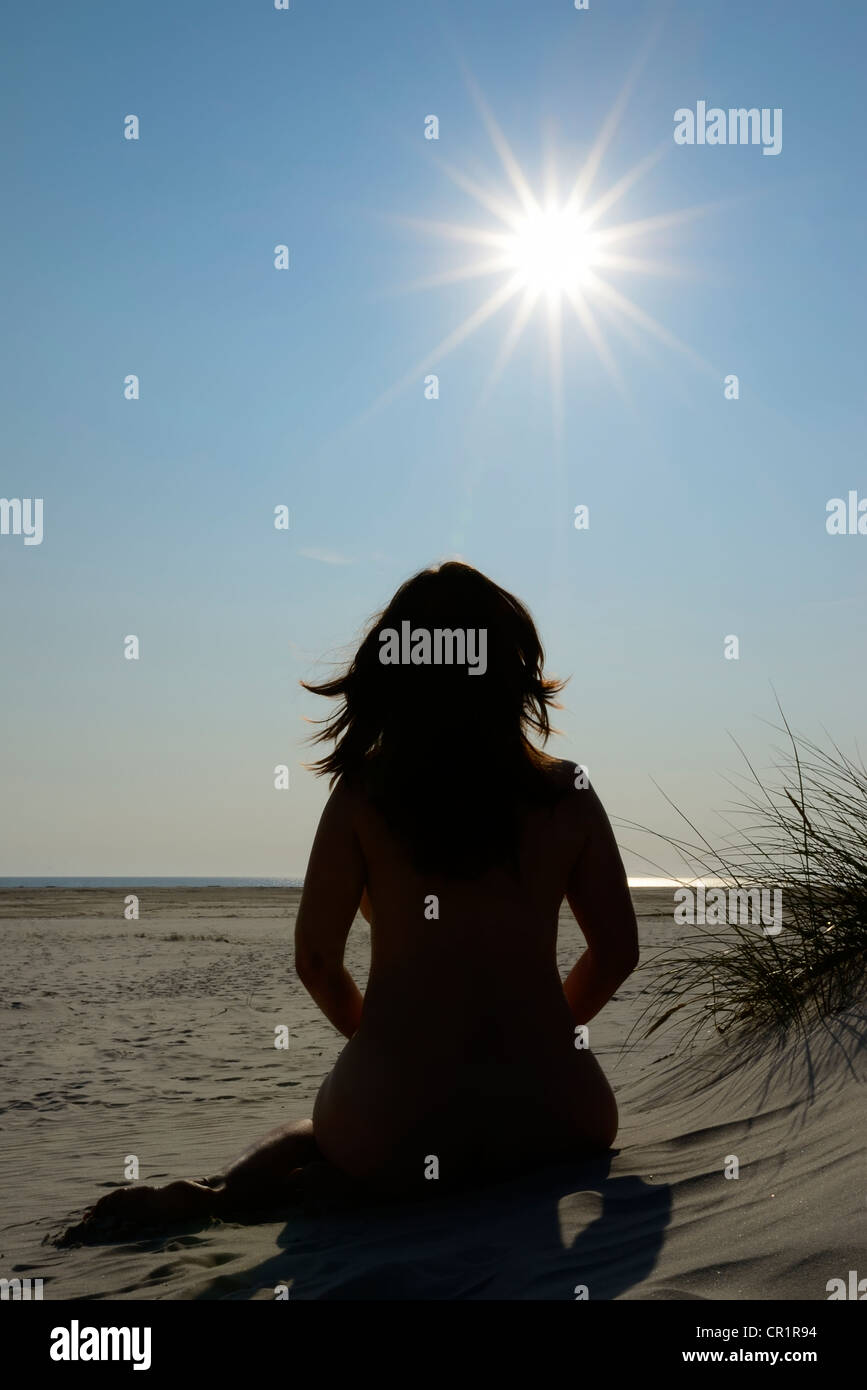 Sun-worshipping woman sunbathing in the dunes, nude beach, Amrum Island,  Nordfriesland, North Frisia, Schleswig-Holstein Stock Photo - Alamy