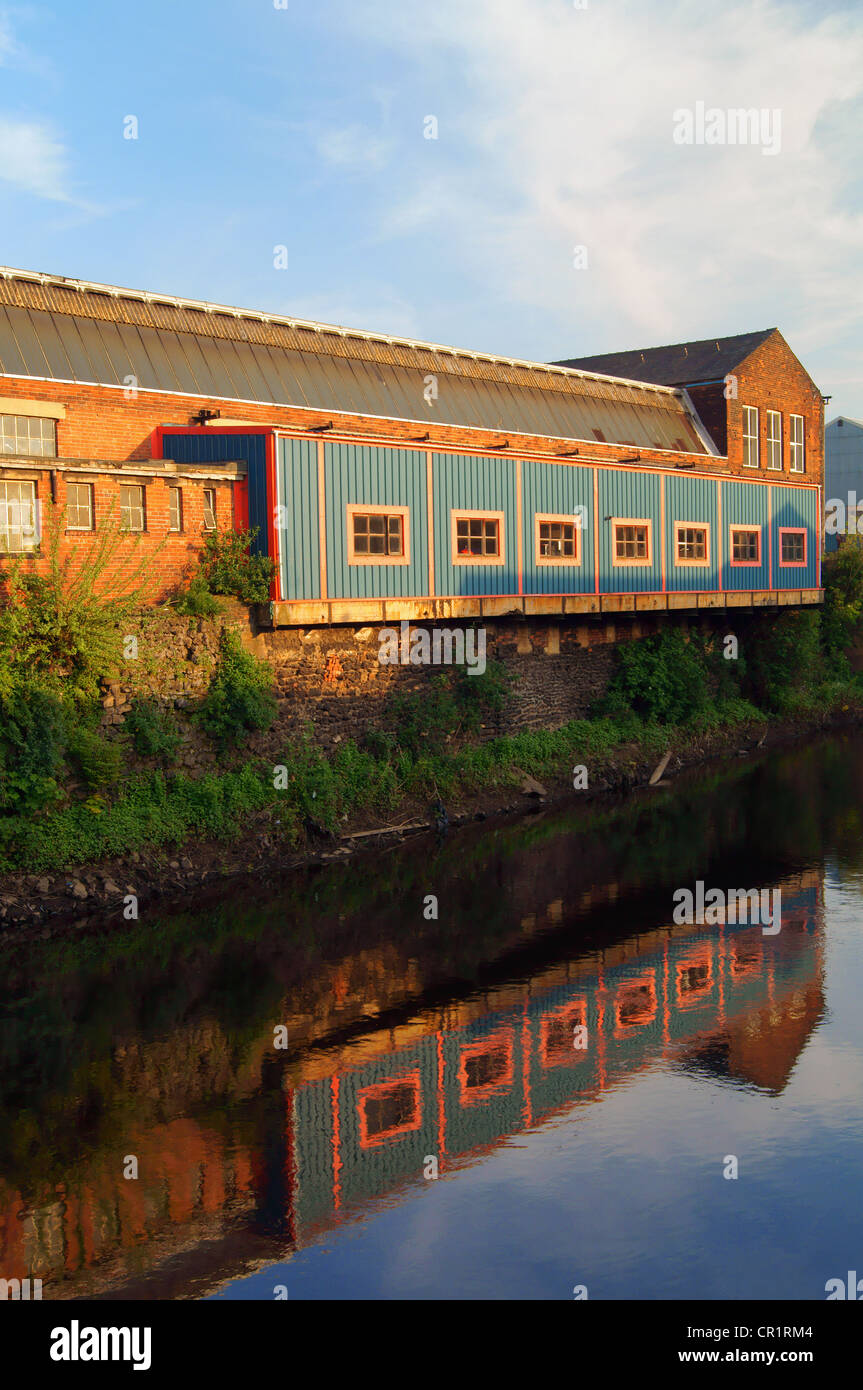 UK,South Yorkshire,Sheffield,Five Weirs Walk,Factory next to River Don near Newhall Bridge Stock Photo