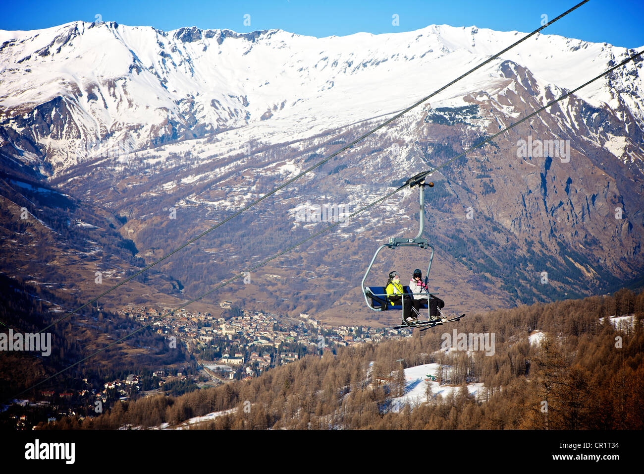 Skiers on ski chair lift in Bardonecchia Italy Stock Photo