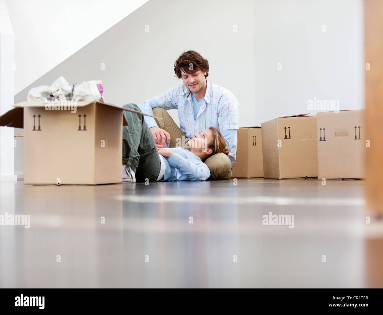 Couple sitting with cardboard boxes Stock Photo