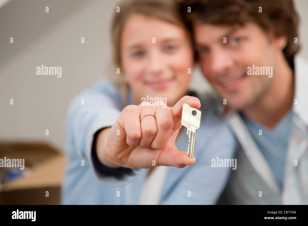 Woman holding key to new home Stock Photo - Alamy