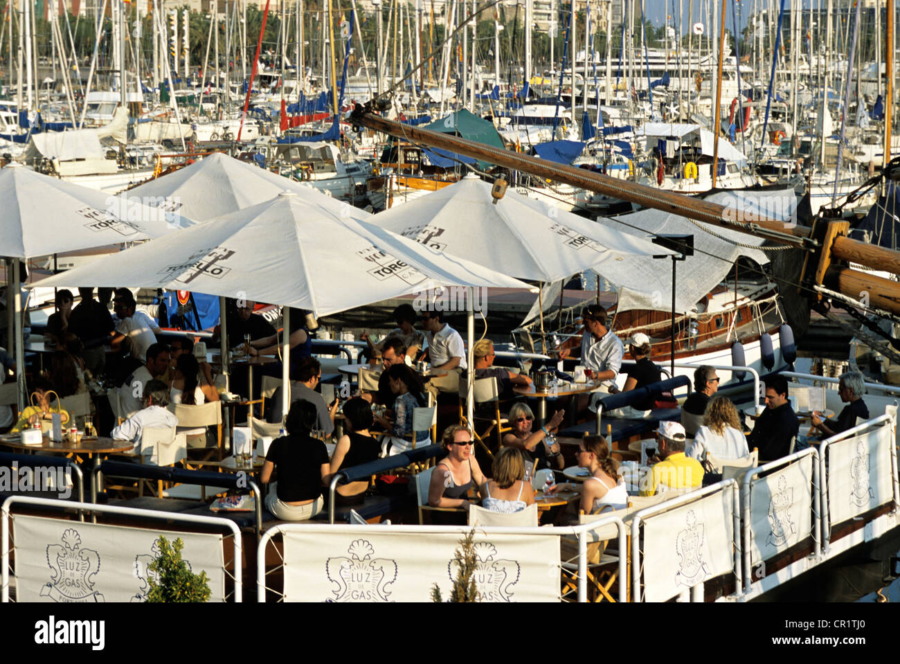 Spain, Catalonia, Barcelona, Port Vell, terrace of a cafe on the marina Stock Photo