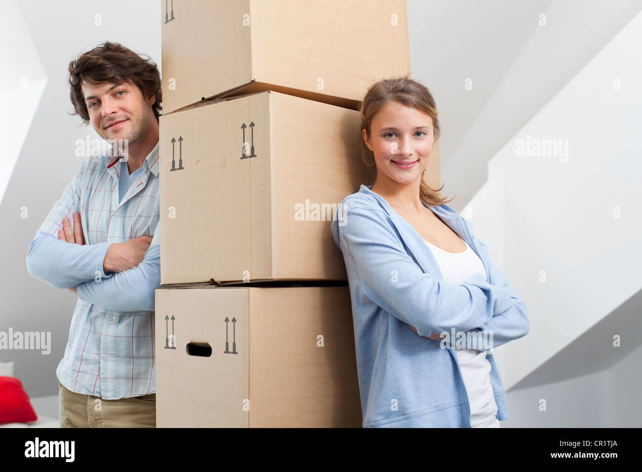 Couple with stack of cardboard boxes Stock Photo