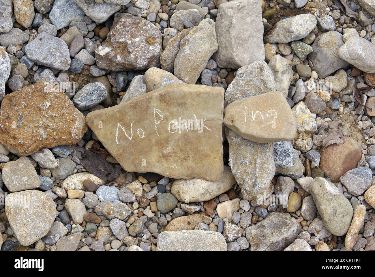 No Parking written on two rocks. Stock Photo