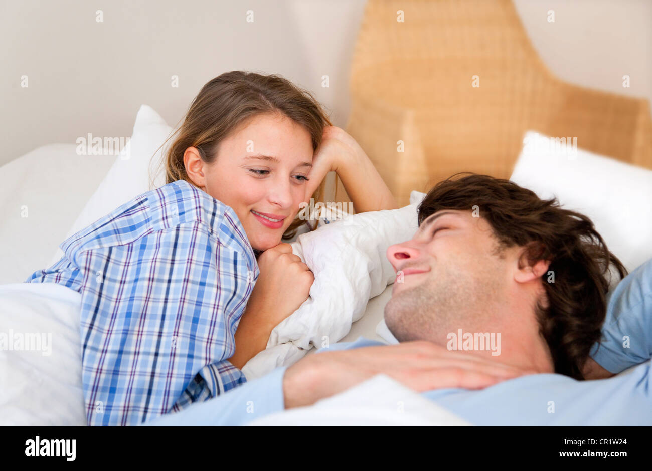 Smiling couple relaxing in bed Stock Photo