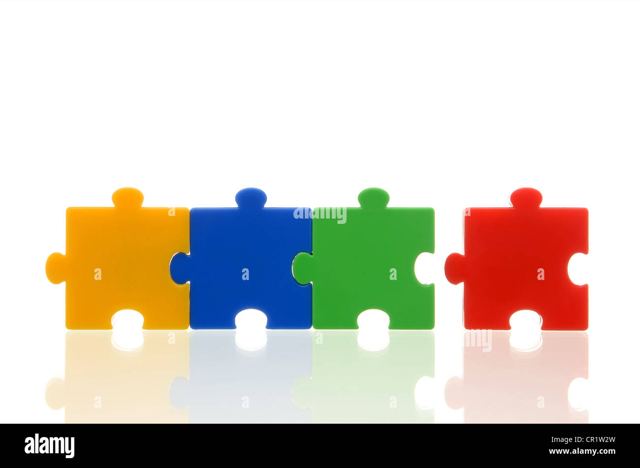 Different coloured puzzle pieces, three puzzle pieces connected, one single puzzle piece, symbolic image for team, series Stock Photo
