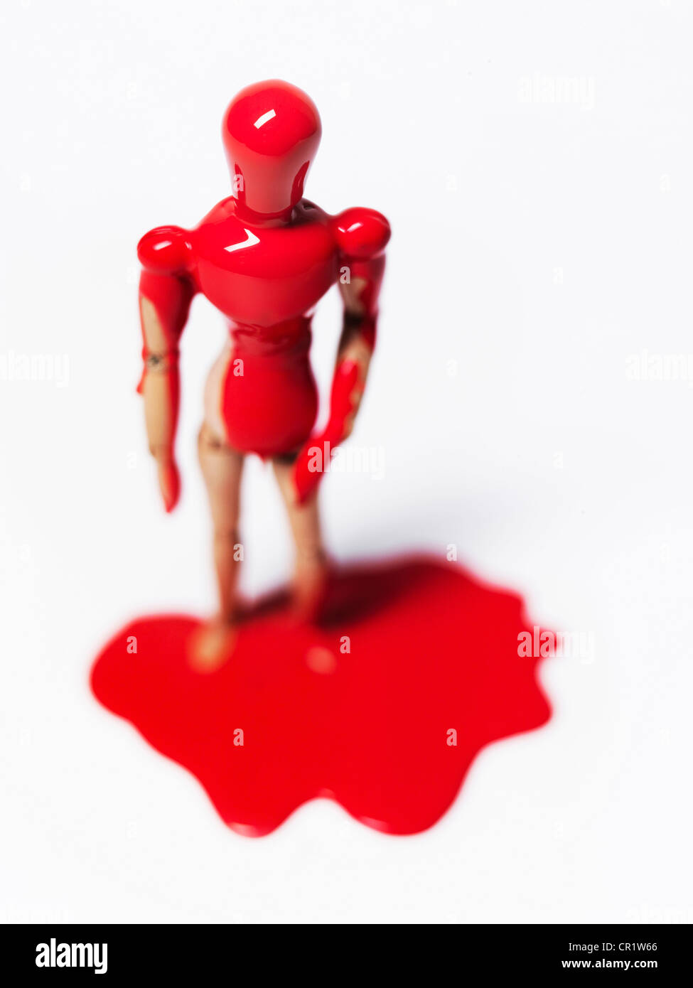 Wooden figurine splashed with paint Stock Photo