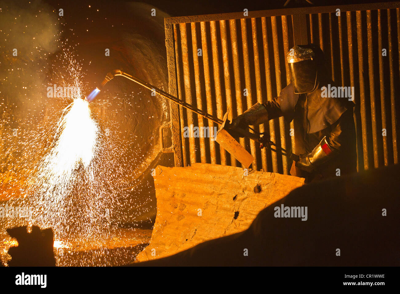 Welder at work in steel forge Stock Photo