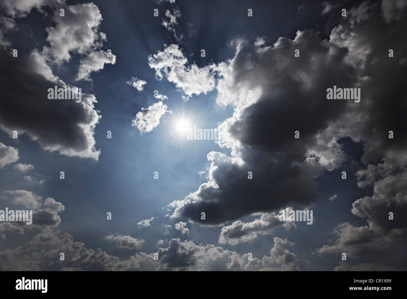 Sun and clouds in blue sky Stock Photo