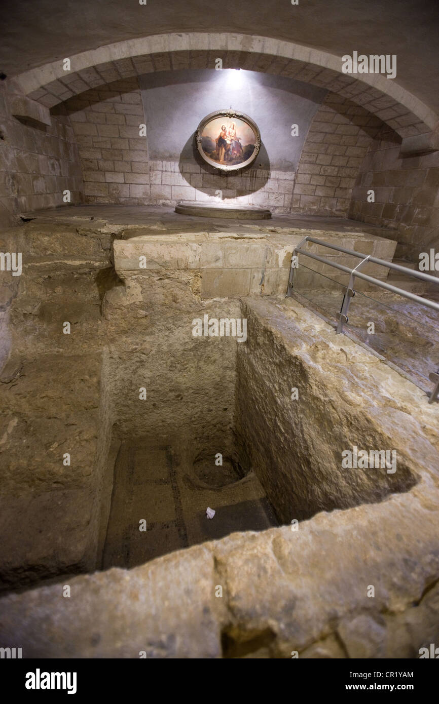 Ancient water pit, ritual bath, and floor mosaics in the crypt of the Church of St. Joseph, Nazareth, Israel Stock Photo