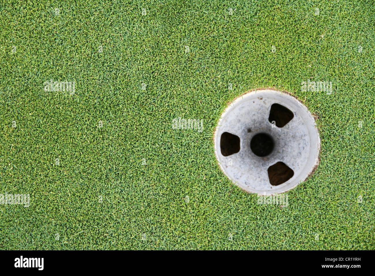 Golf cup with green grass surrounding it Stock Photo Alamy