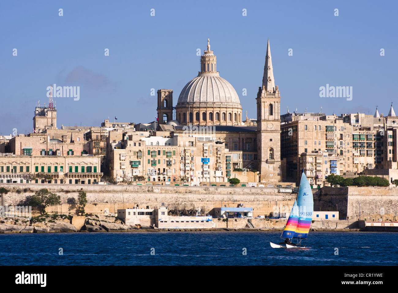 Catamaran sailing in front of Valetta skyline, Malta. Stock Photo