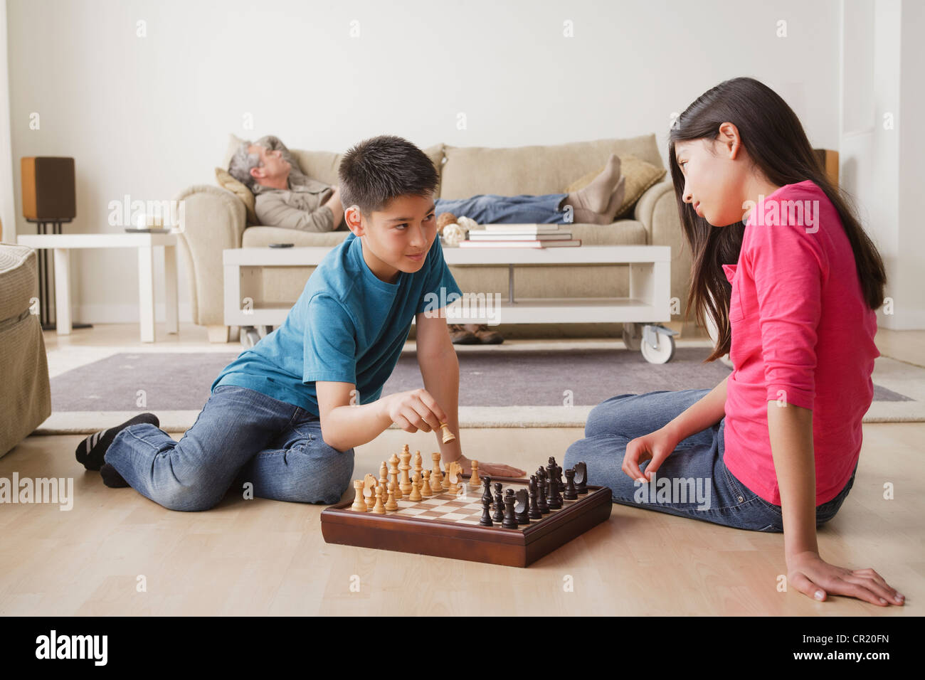 USA, California, Los Angeles, Siblings playing chess game Stock Photo