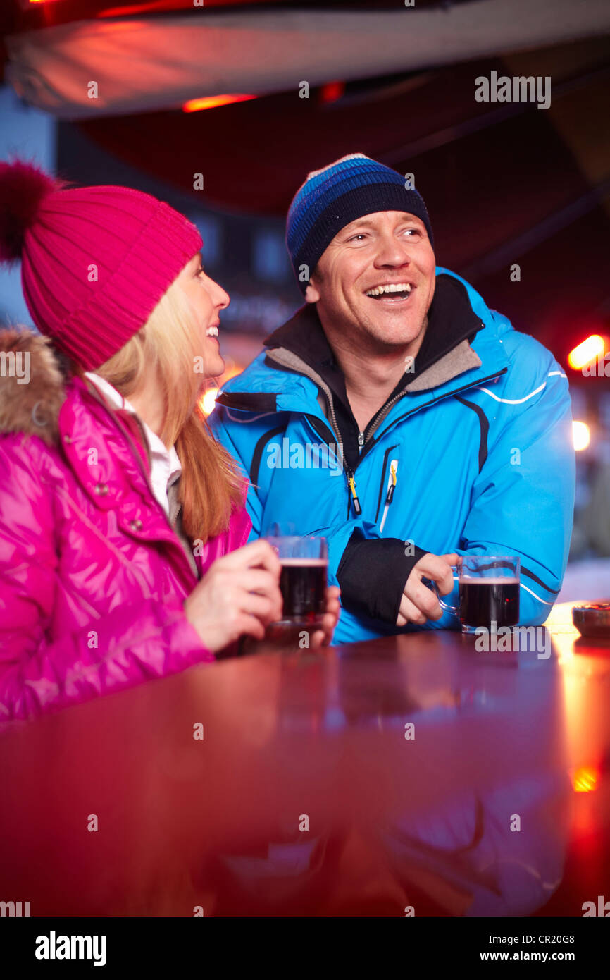 Couple having coffee outdoors in winter Stock Photo