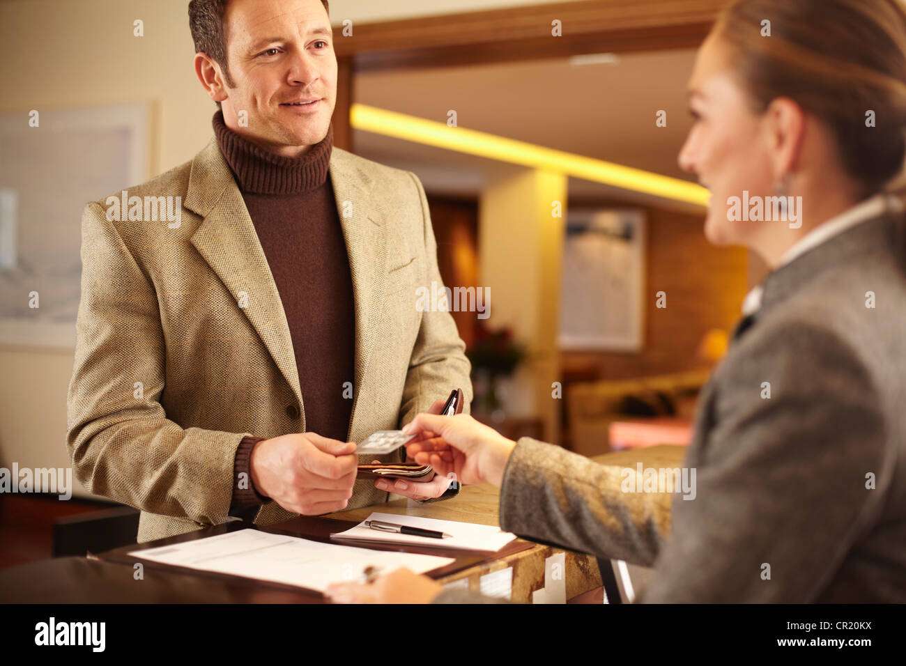 Man checking in to hotel Stock Photo