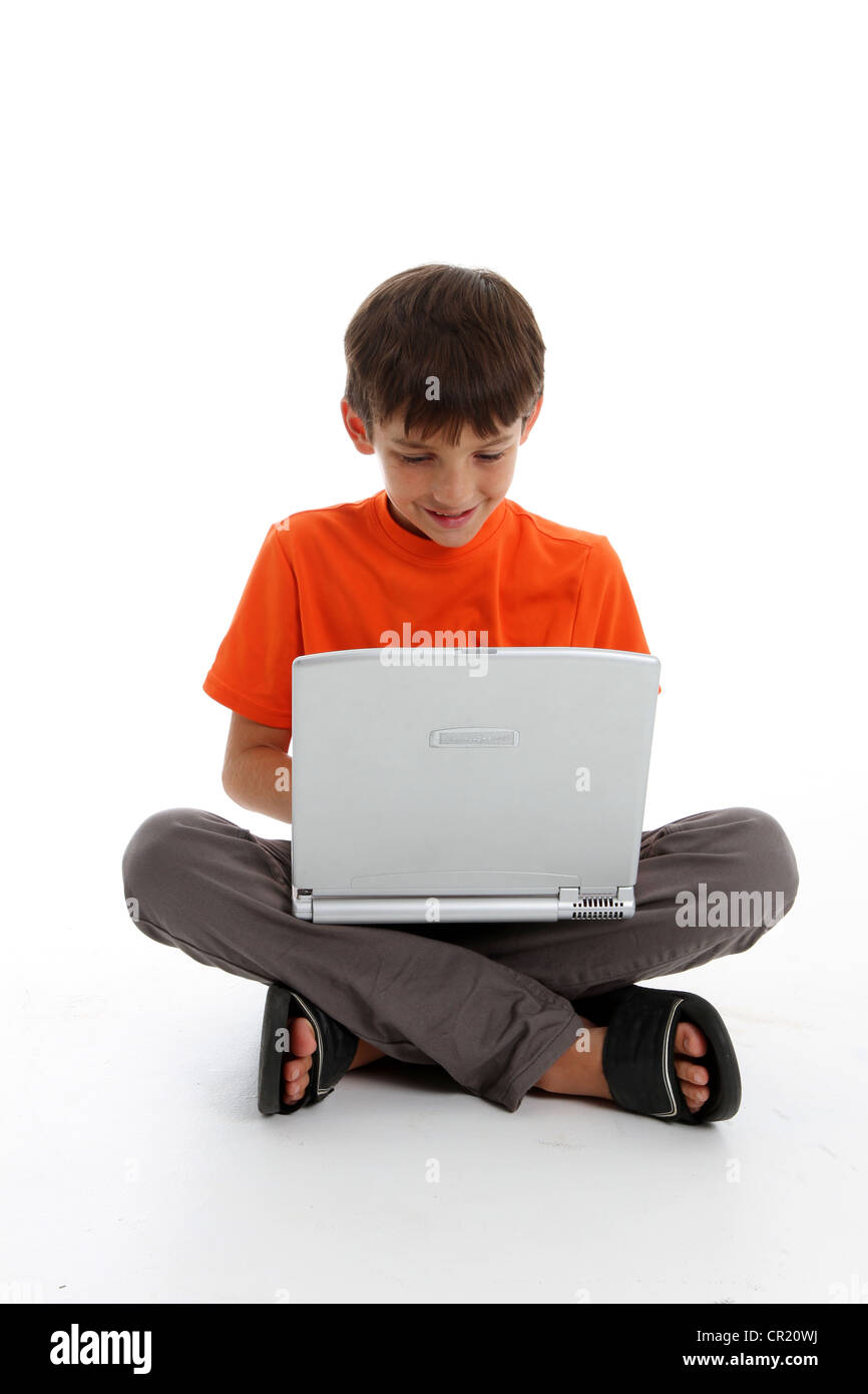 Young Boy Playing on Computer on White Background Stock Photo - Alamy