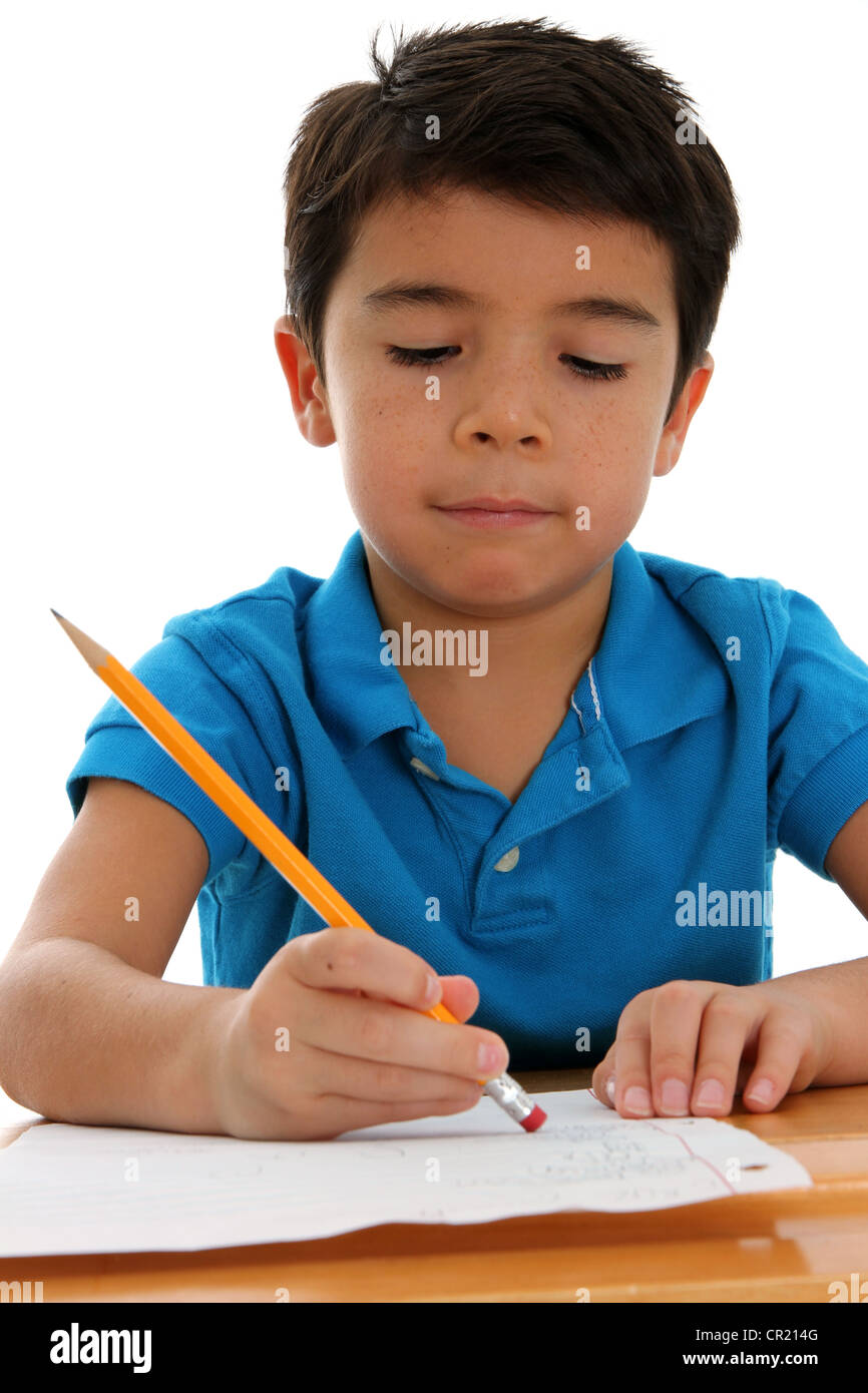 Elementary aged boy at his desk set on a white background Stock Photo