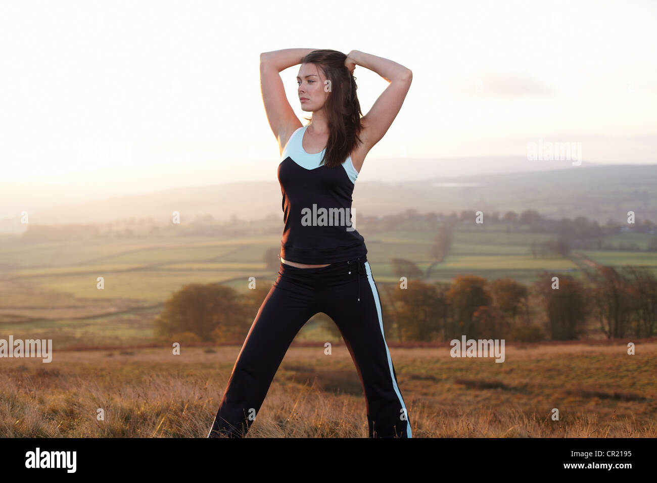 Runner stretching in rural landscape Stock Photo