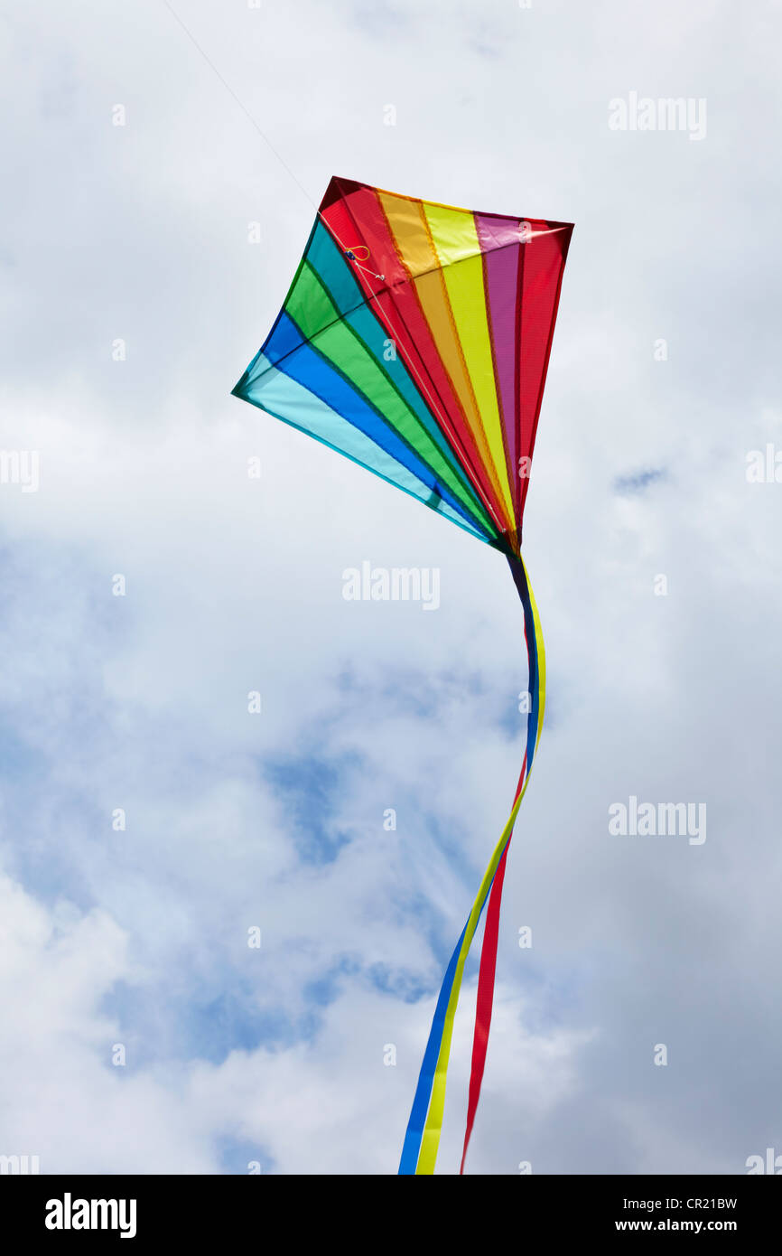 Kite flying in cloudy sky Stock Photo