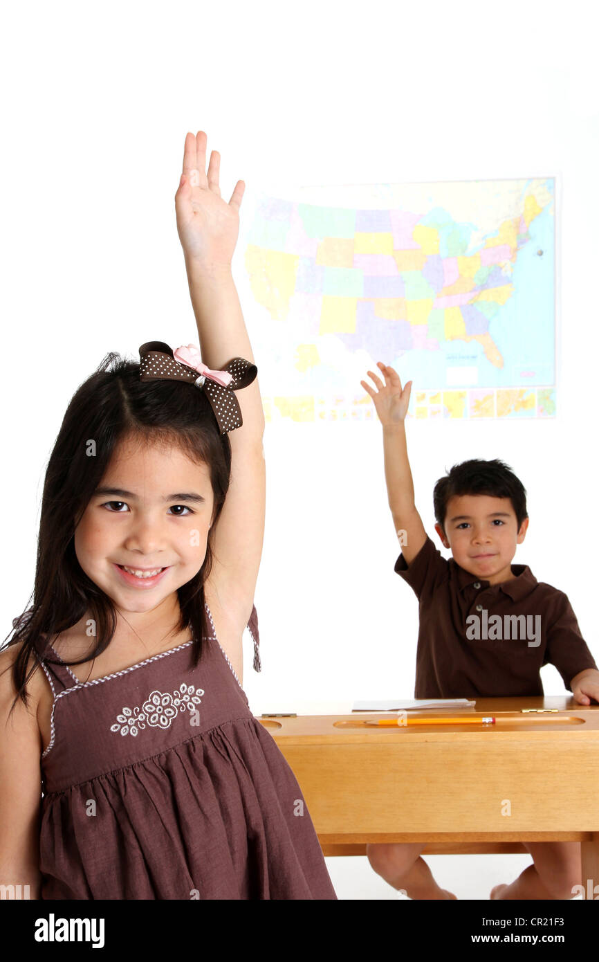 Young Children Raising Their Hands in School Stock Photo Alamy