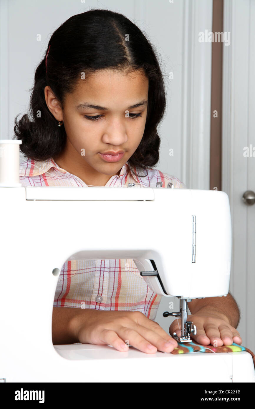 Girl using a sewing machine to make crafts Stock Photo Alamy