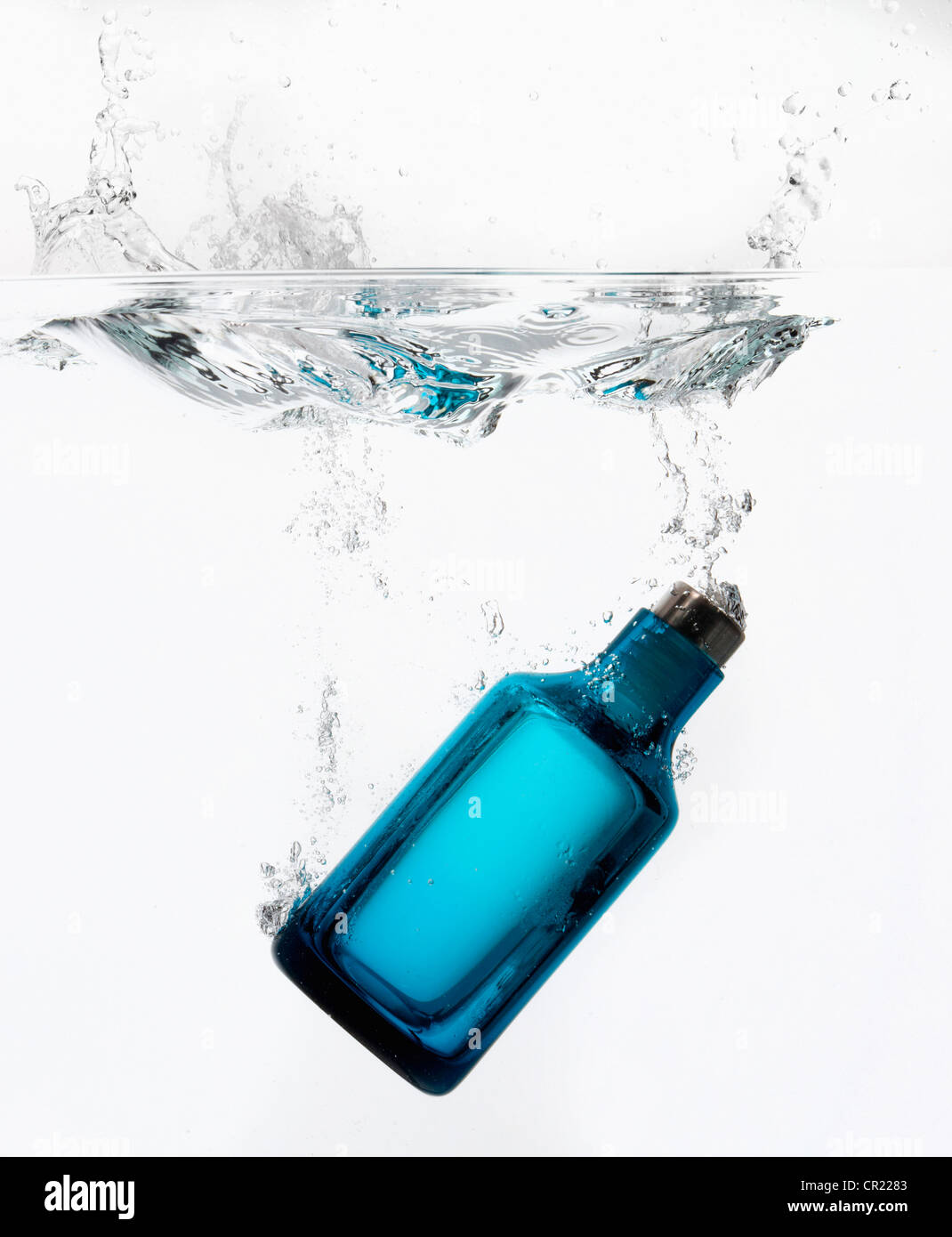 Bottle splashing in water Stock Photo