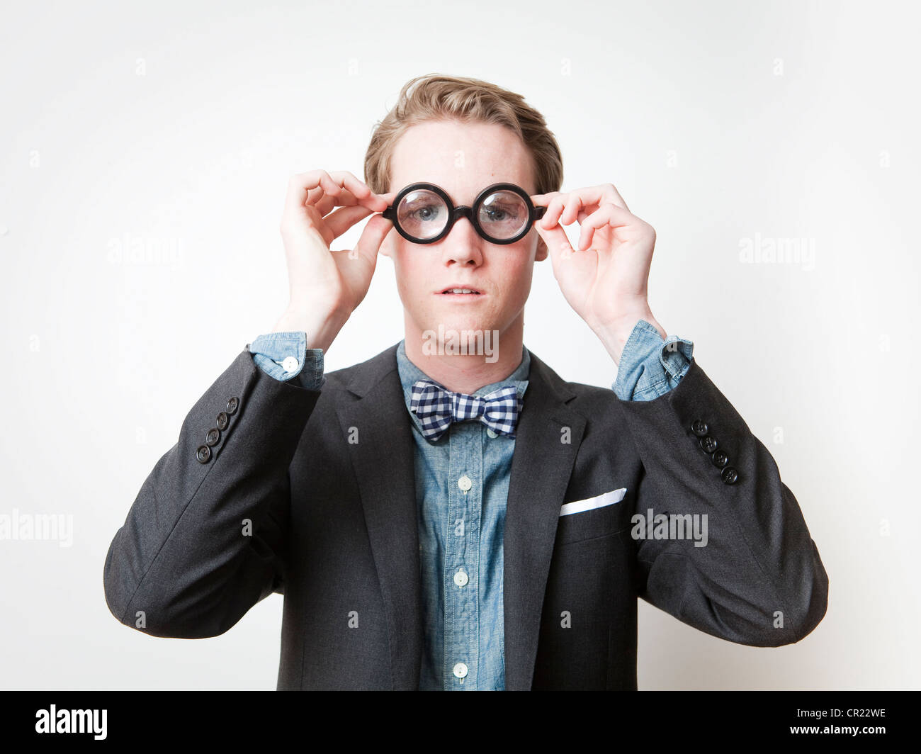 Studio shot of young man wearing funny glasses Stock Photo