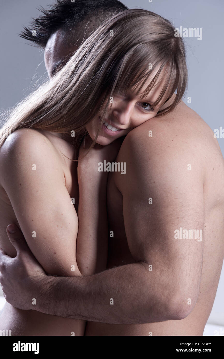 Smiling nude couple hugging Stock Photo