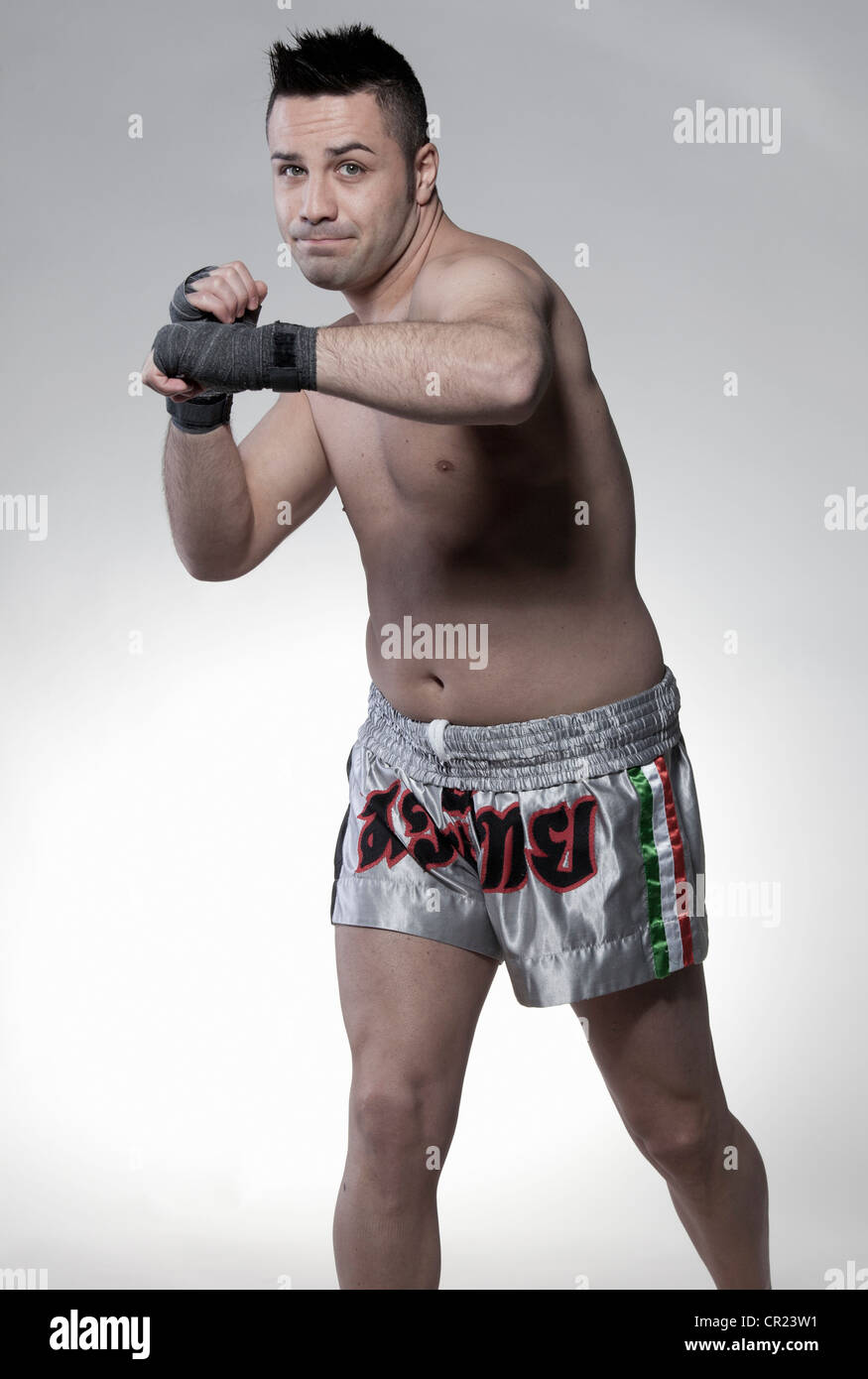 Boxer jabbing with arm Stock Photo