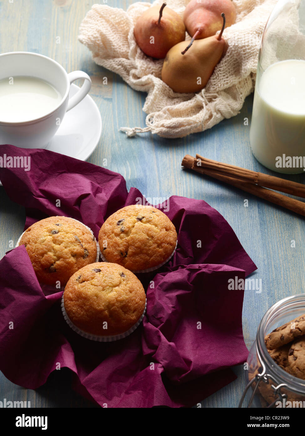 Muffins, pears, and milk on table Stock Photo