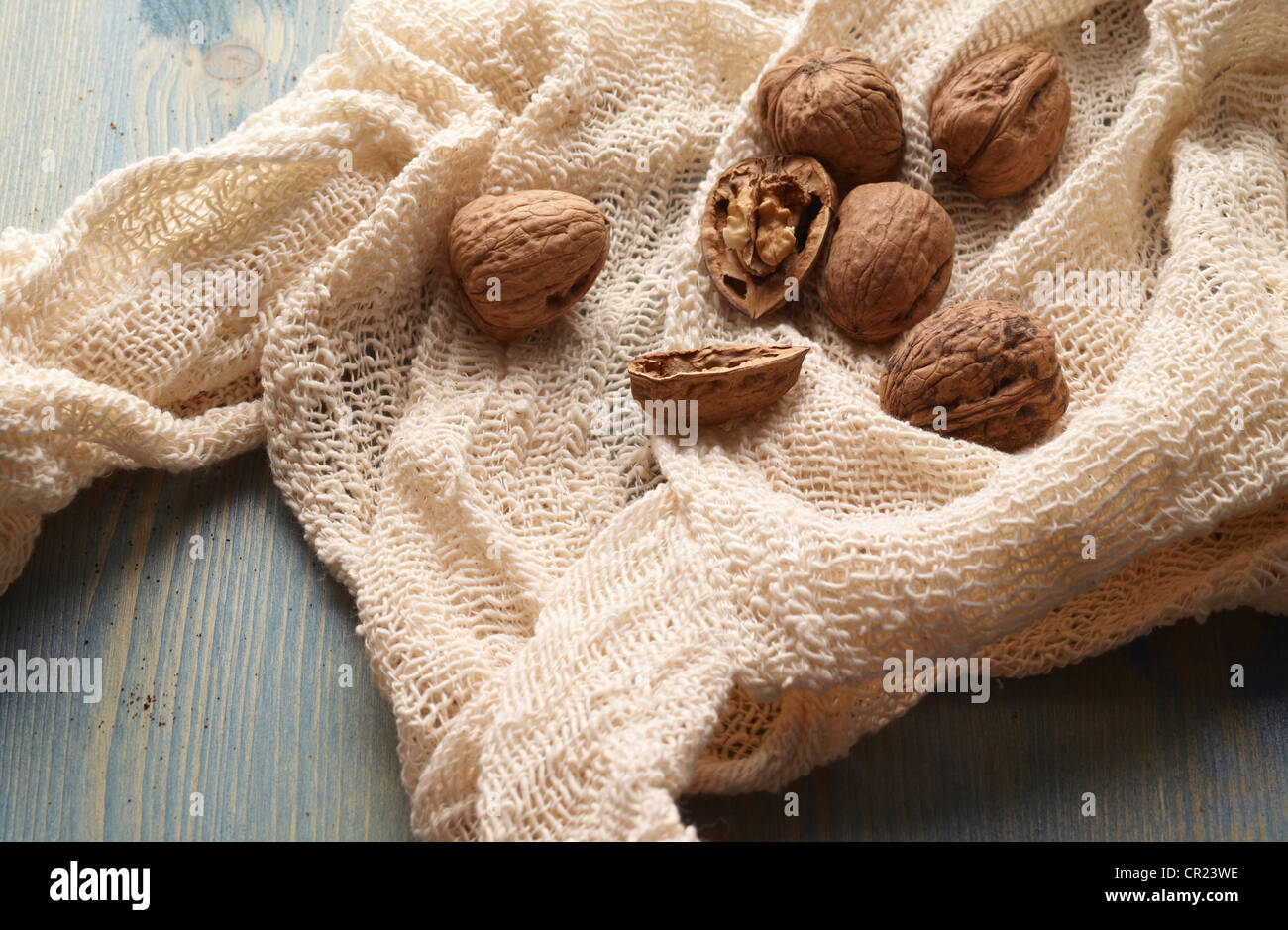 Walnuts in knitted fabric on table Stock Photo