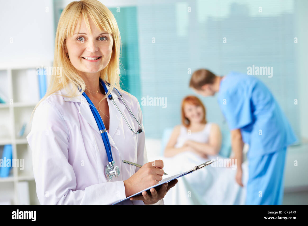 Portrait of smiling female nurse looking at camera in hospital Stock ...