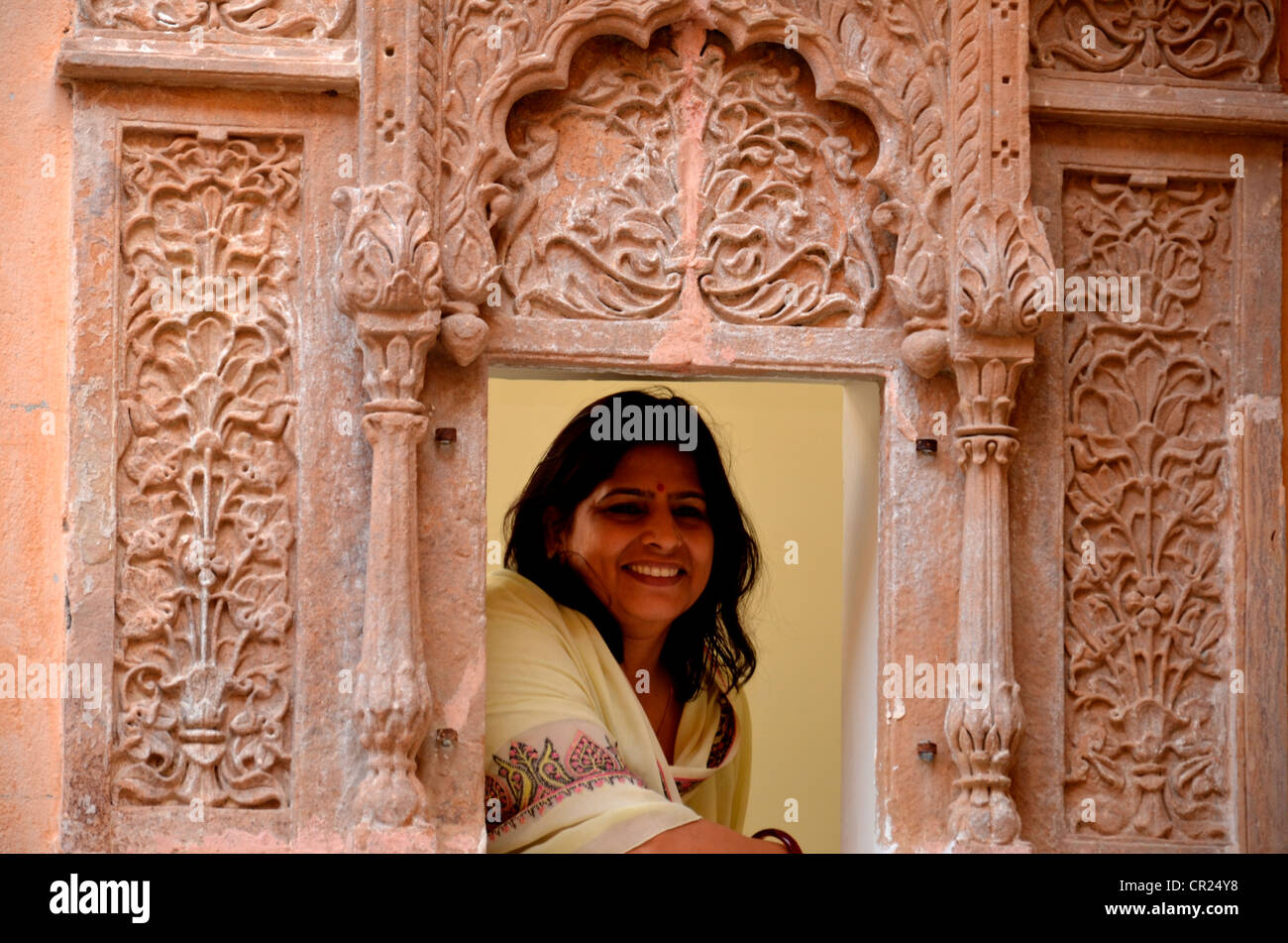 A rajasthani woman looking through jharokha ( window) Stock Photo