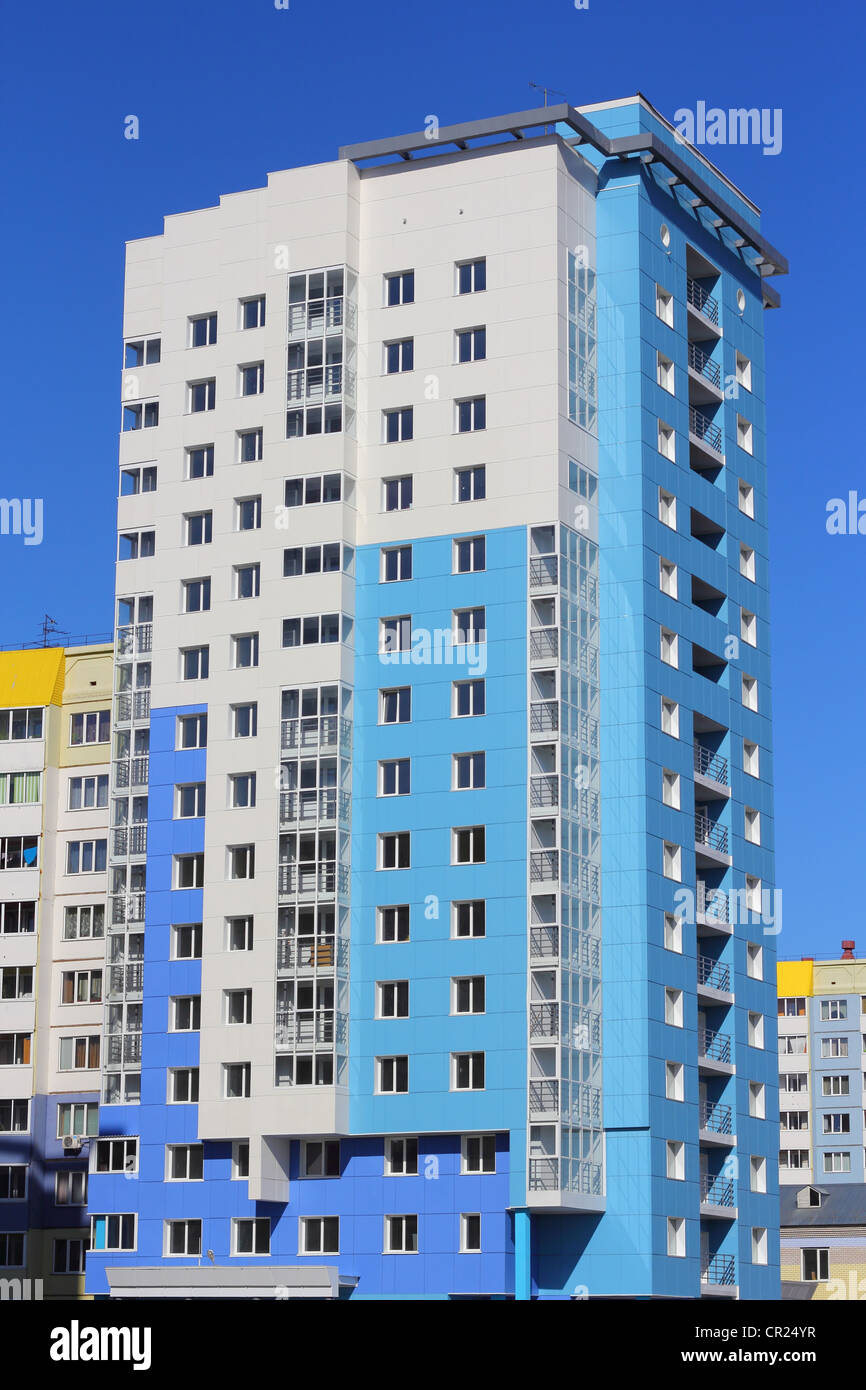 The inhabited high house against the blue sky Stock Photo - Alamy
