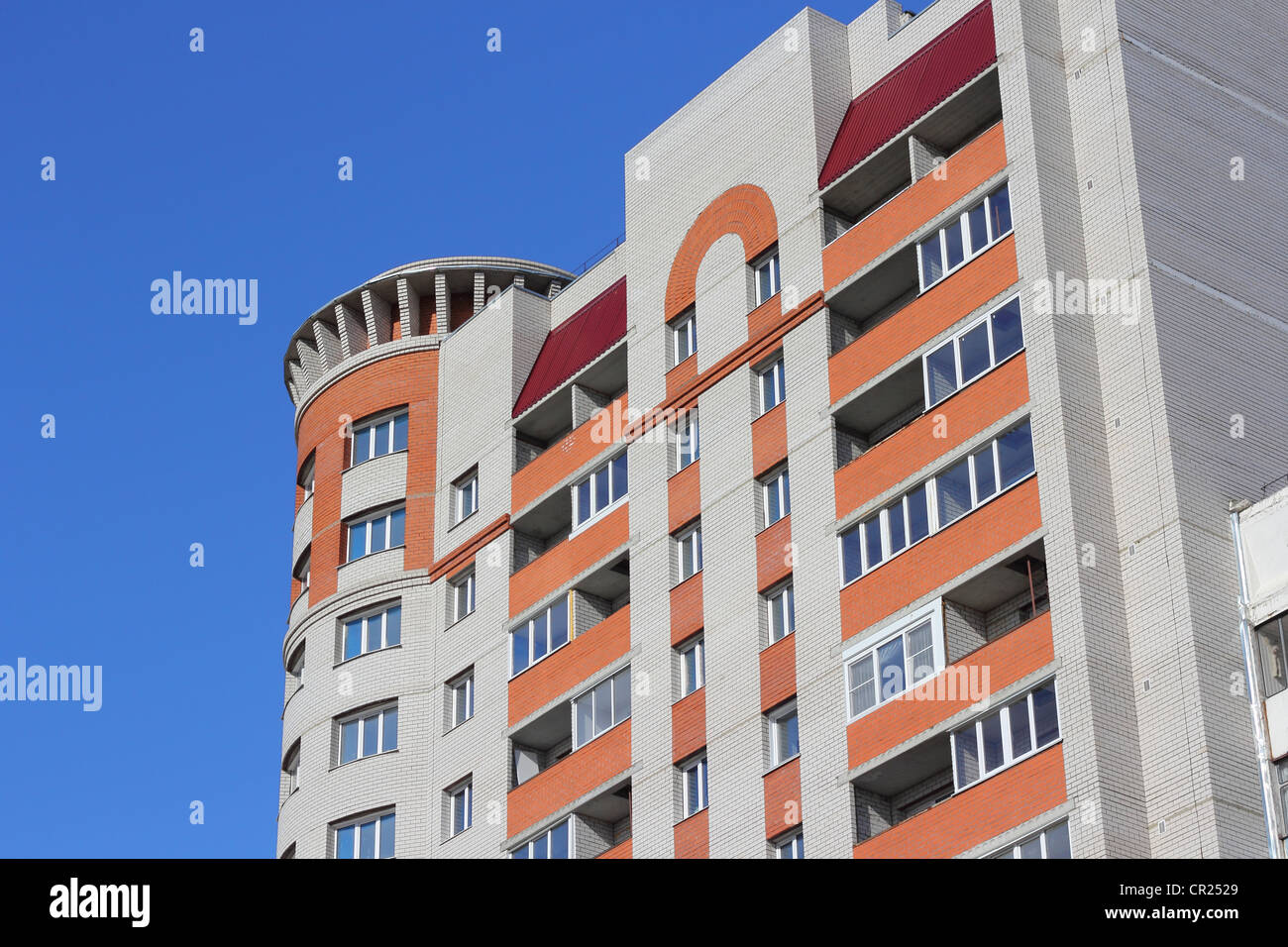 The inhabited high house against the blue sky Stock Photo - Alamy