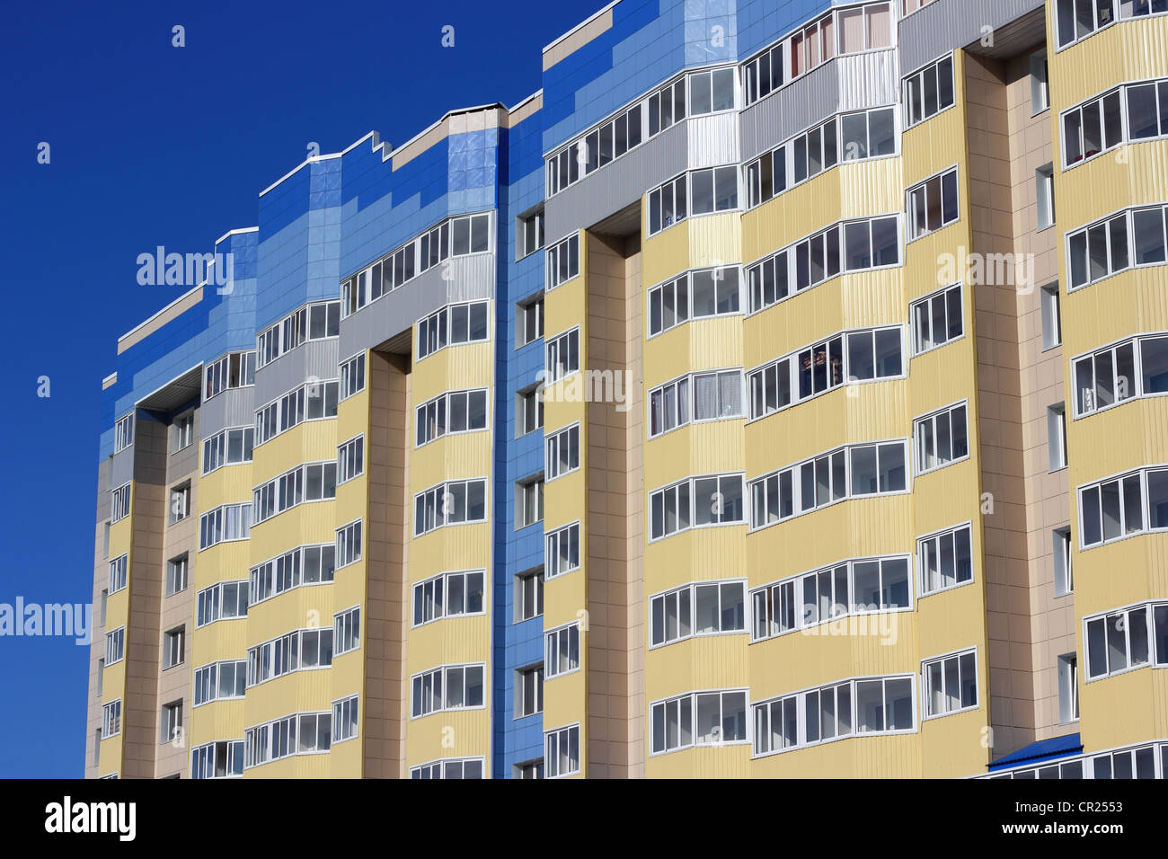 The inhabited high house against the blue sky Stock Photo - Alamy