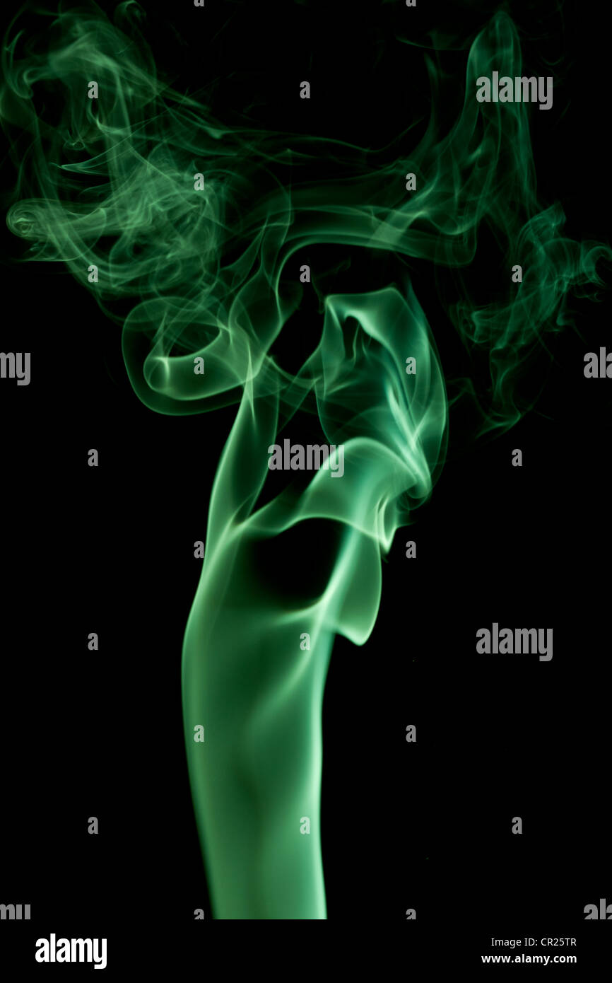 green abstract smoke on the black background Stock Photo - Alamy