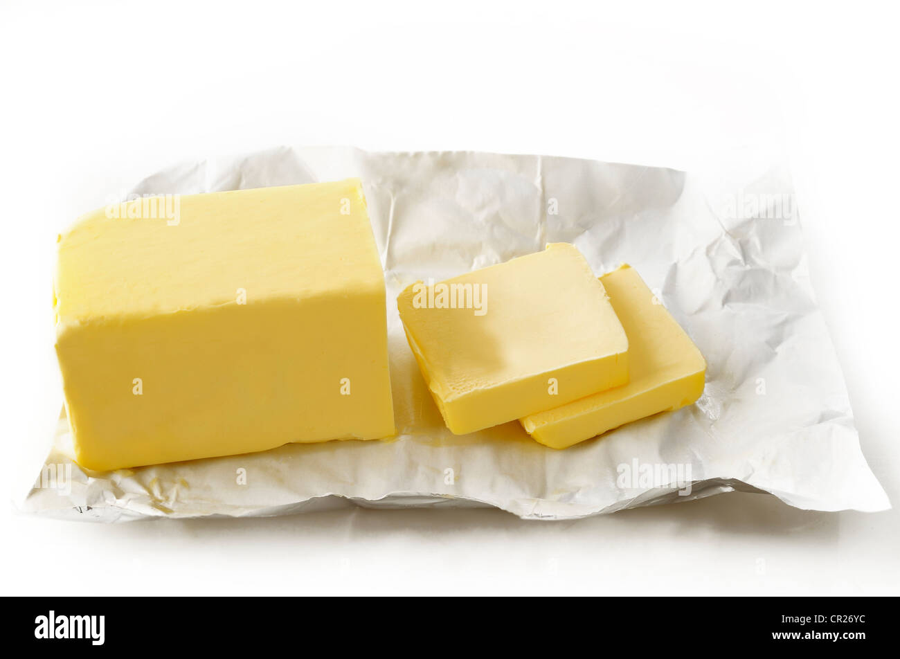 Piece of butter in paper on white background Stock Photo