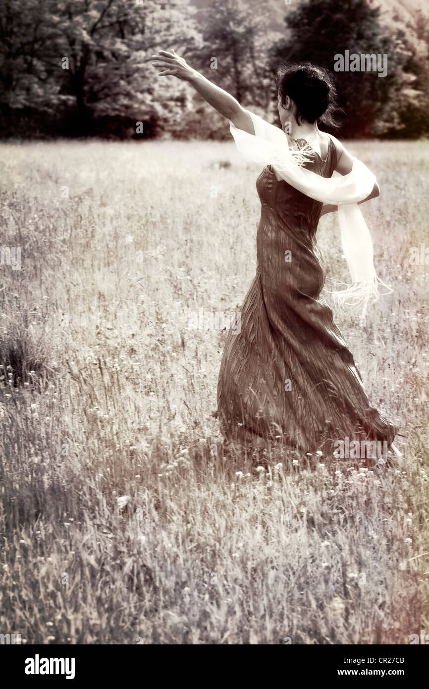 woman dancing on a lawn Stock Photo